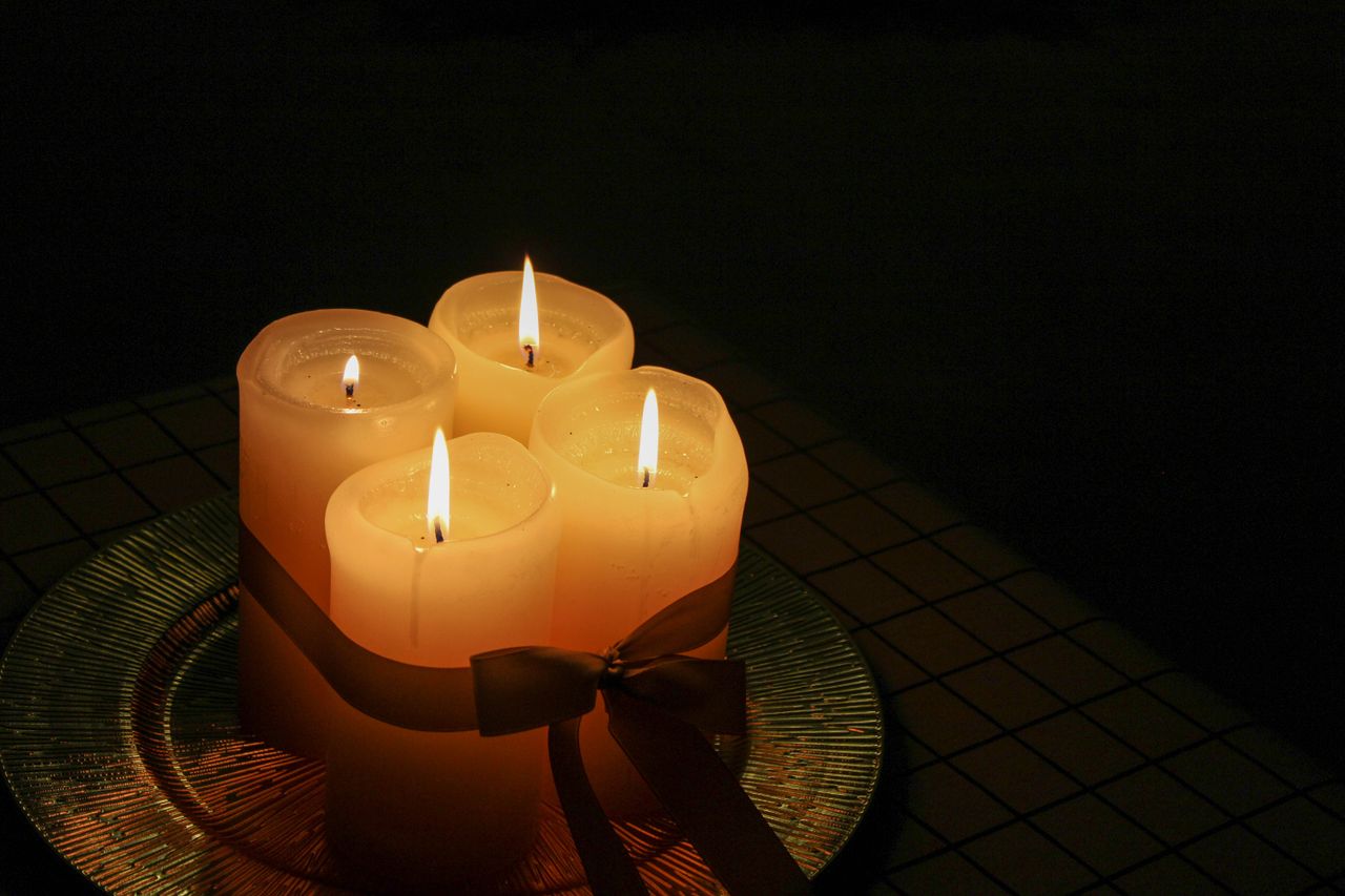 Hand-poured candles burning on an evening table